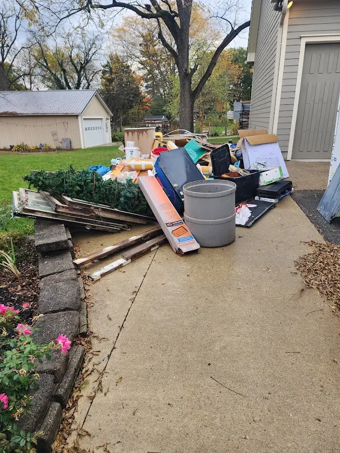 Dumpster being loaded with debris for Estate Cleanout Dumpster Rental in Bloomingdale